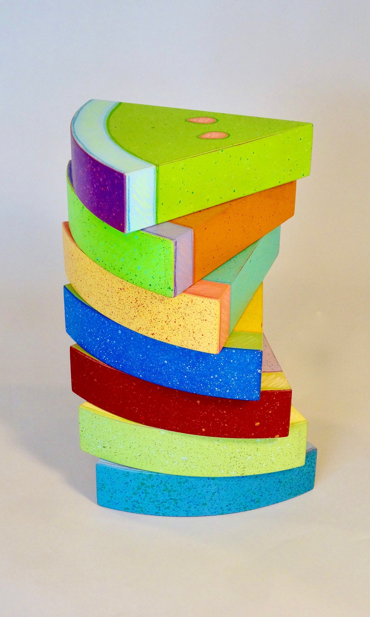 Wooden sculpture depicting slices of watermelon stacked on each other. All of the slices are unnatural colors including orange, green, purple, and blue. 2020 7.5"x7.5"x1.75" each (7 pieces total) painted wood Sean O'Meallie