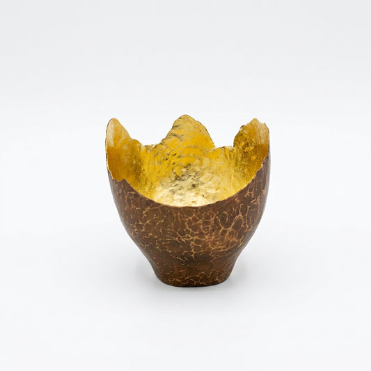Decorative bowl with gold interior and cracked brown exterior.