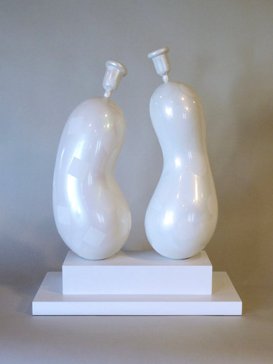 An all white sculpture depicting two balloons sitting atop two wooden blocks. The balloons are both pear shaped. 2012 22"x17"x8.75" painted wood by Sean O'Meallie