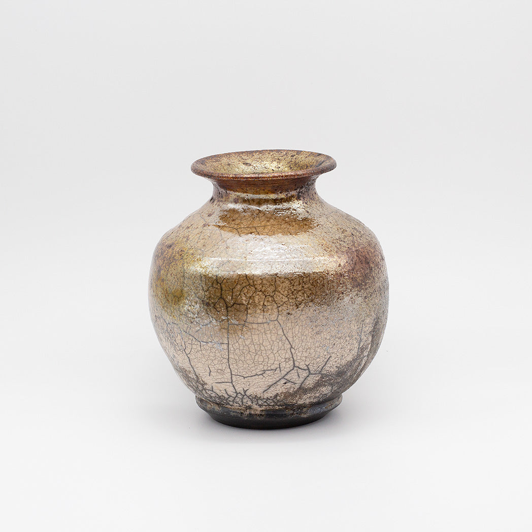 A small ceramic vase with a rounded bulbous body, flared rim, and glossy crackled glaze in metallic gold, bronze, and brown tones.